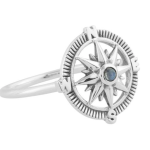 silver ring with compass design and blue gem